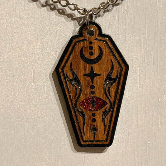Handcrafted gothic coffin necklace with crescent moon motif and glossy resin finish