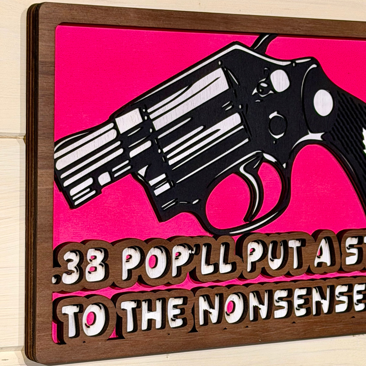 Angled view showing the layered wooden construction of the wall sign