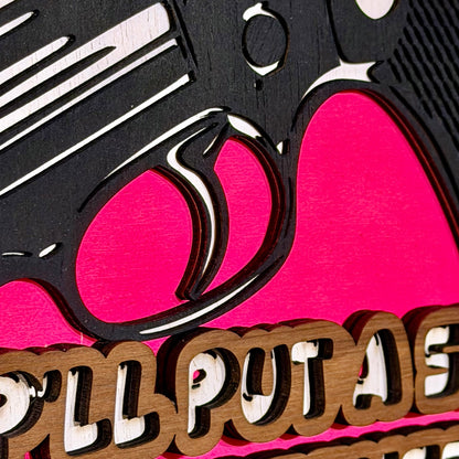 Close-up detail of layered revolver artwork and raised wooden lettering