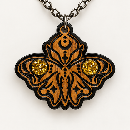 Ornate walnut moth pendant necklace with two gold glitter circular accents