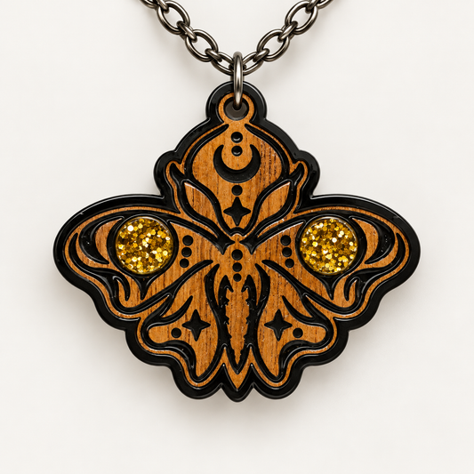 Ornate walnut moth pendant necklace with two gold glitter circular accents