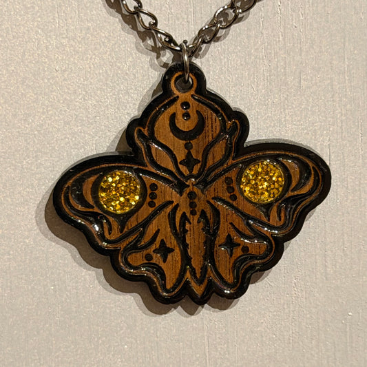 Sanctum Hex gothic moth pendant showing celestial details and curved black engraved lines