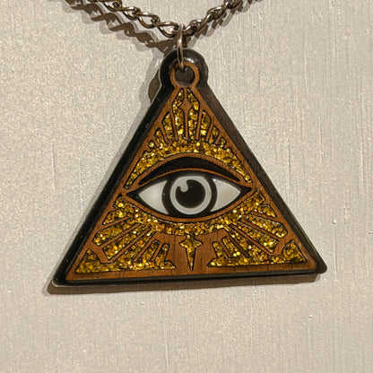 Handcrafted triangular all-seeing eye pendant with black details and gold glitter