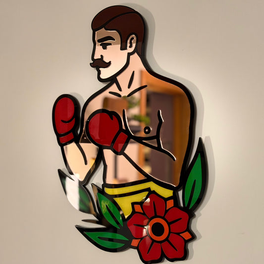 Side view of The Boxer wall hanging showing layered acrylic in rose gold mirror, deep red, black, green and warm orange with glossy finish.