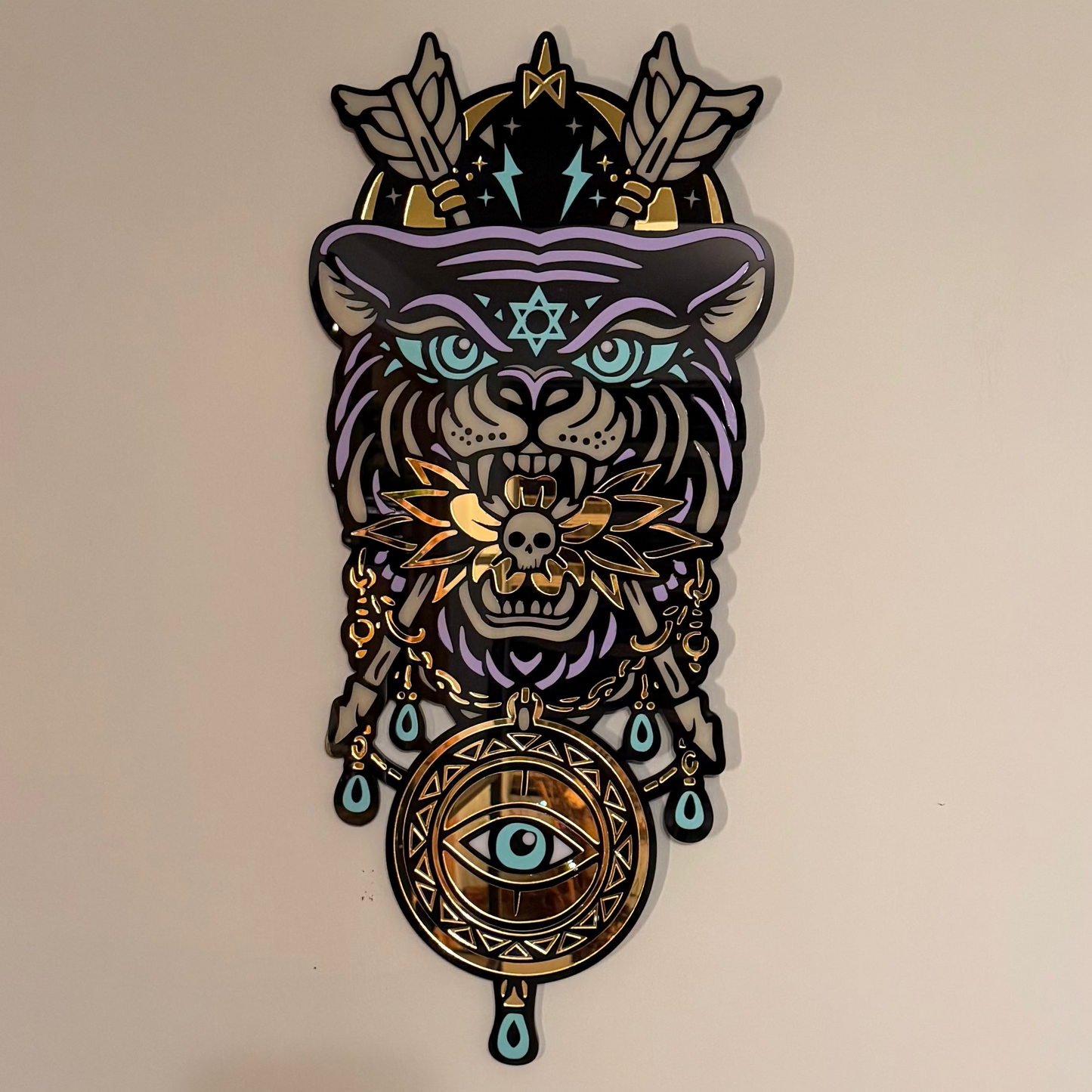 Decorative wall art with a stylized animal design featuring geometric patterns and symbols on a beige background.