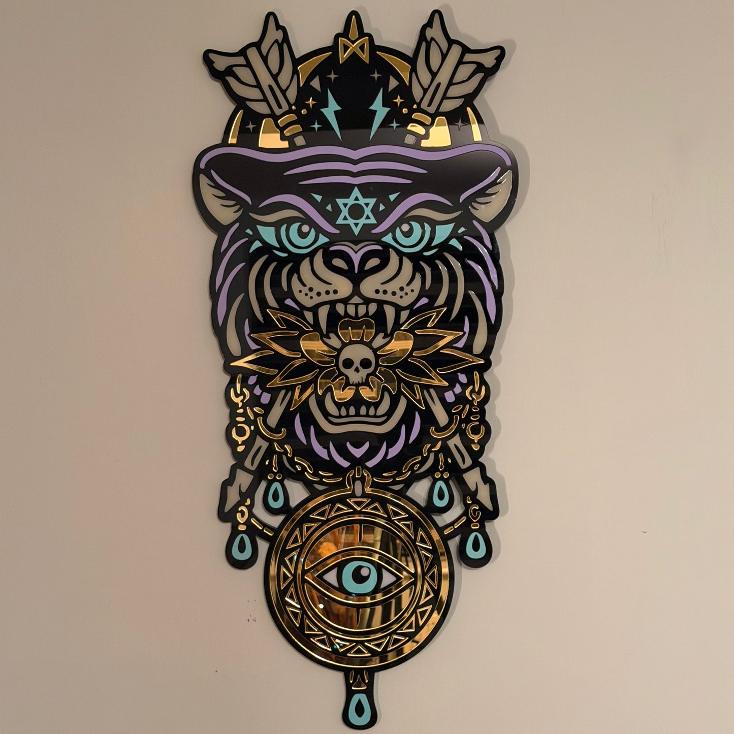 Decorative wall art with a stylized tiger head design featuring geometric patterns and symbols on a beige background.