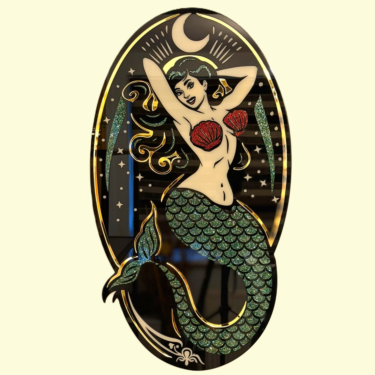 Mermaid design with green scales and red top on a black background