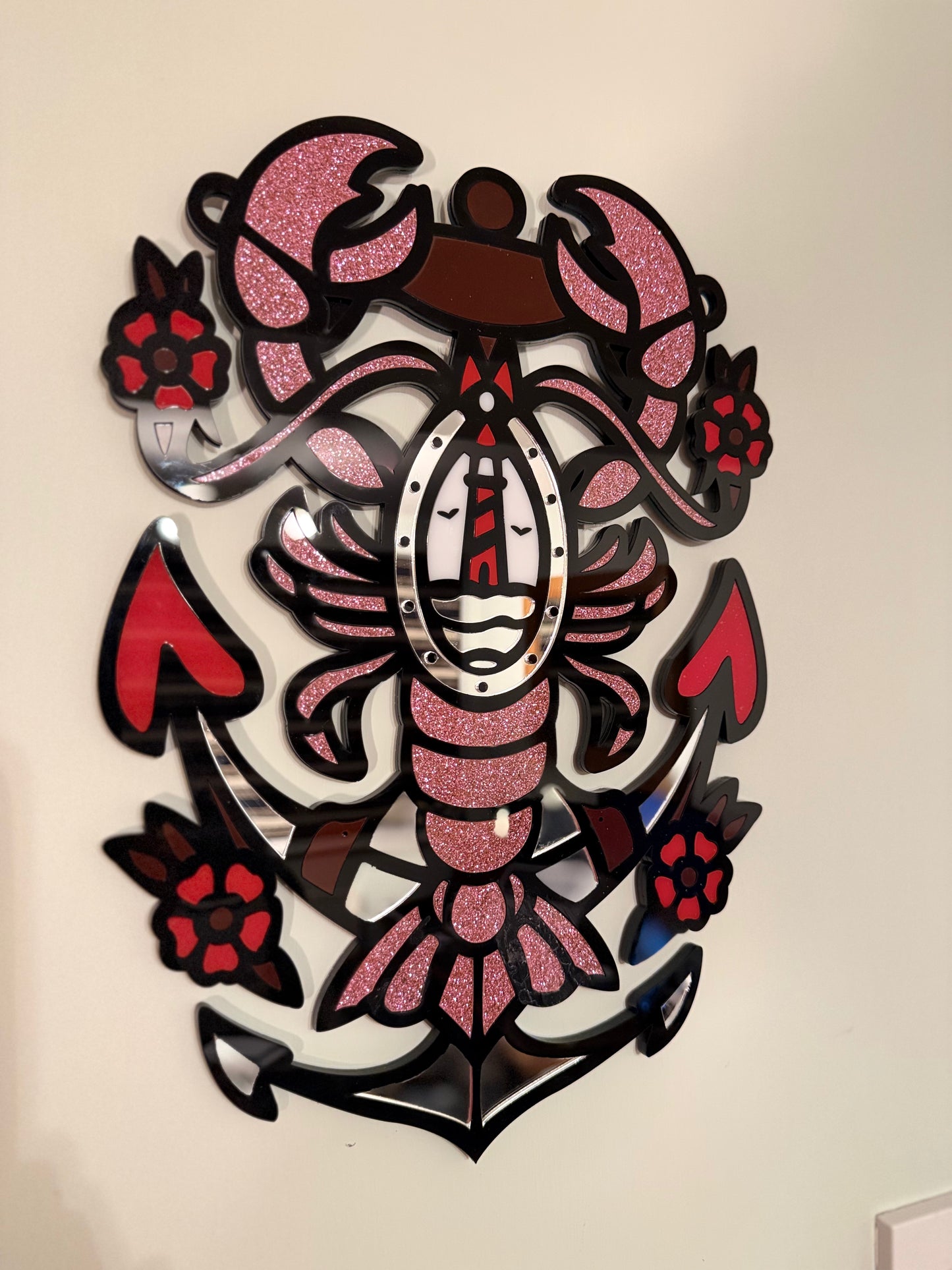 Side view highlighting the layered acrylic construction and glossy finish of the red, black, glitter pink and mirror tones.