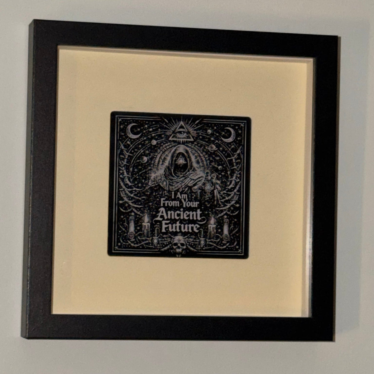 Ancient Future — Framed Esoteric Art in black shadow-box frame, 18 cm square, with warm ivory backing and 95 mm engraved acrylic artwork
