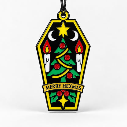 Merry Hexmas coffin ornament on a clean light background