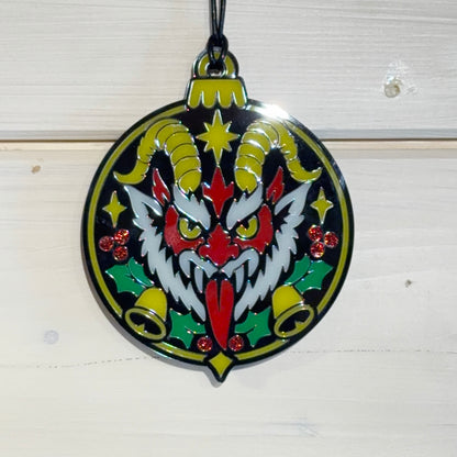 Front detail view of Merry Hexmas Krampus ornament with holly, bells and glitter berries