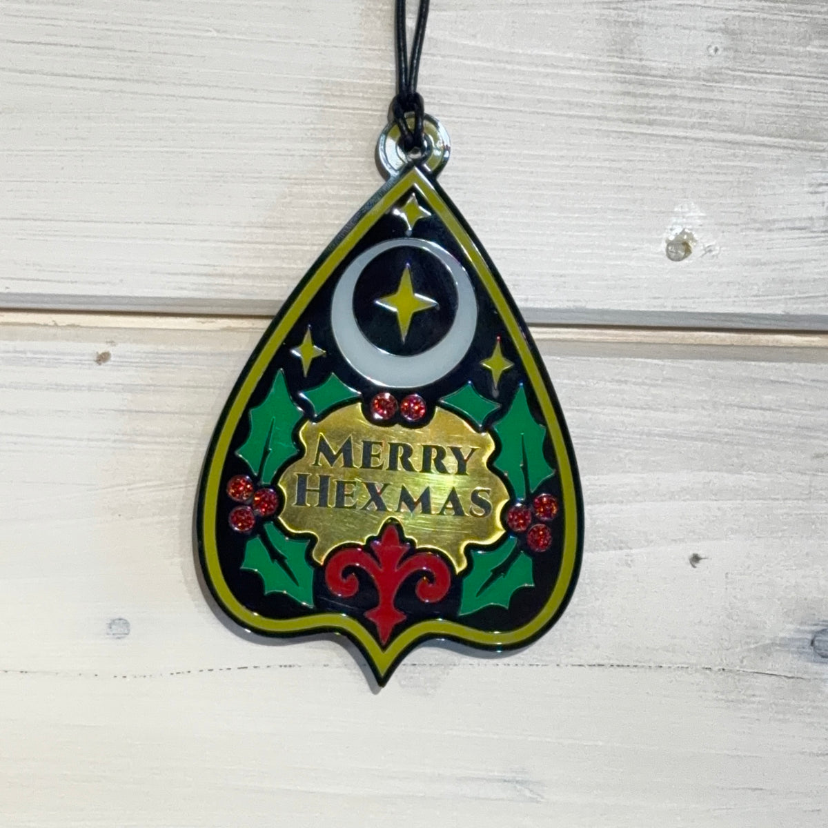 Merry Hexmas Ouija Planchette Ornament showing reflective gold and coloured laser-cut details