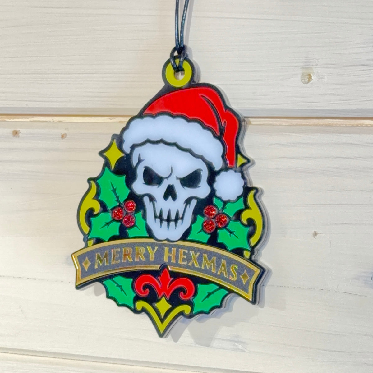 Angled view of Merry Hexmas Santa Skull ornament showing layered construction