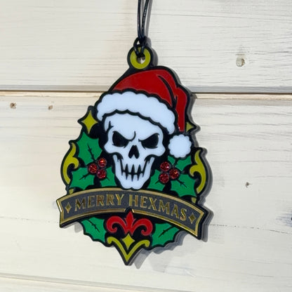 Detailed view of Merry Hexmas Santa Skull ornament with holly, glitter berries and banner text